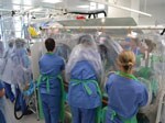 Thumbnail of Isolator–isolator transfer is the safest means of transfer for patients with serious infectious diseases and requires practice in dedicated training exercises, as shown.