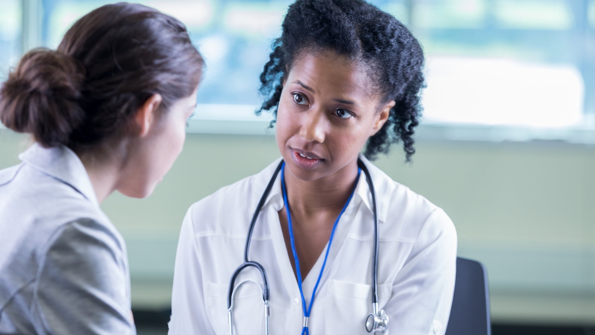 A female doctor talks to a patient