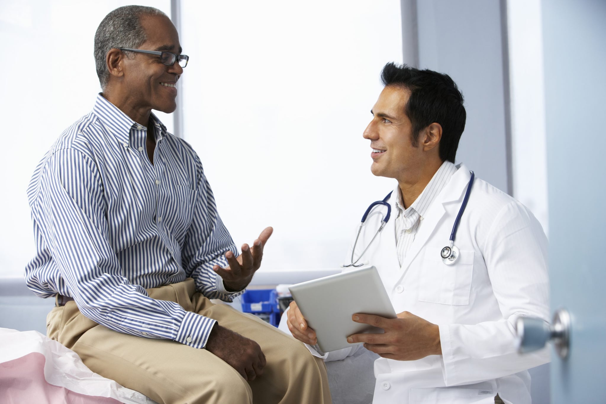 A clinician speaks with a smiling patient