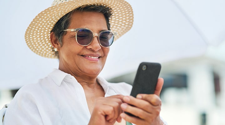 Older woman looking at her phone on a warm day