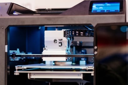 Working 3d printer printing white plastic prototype