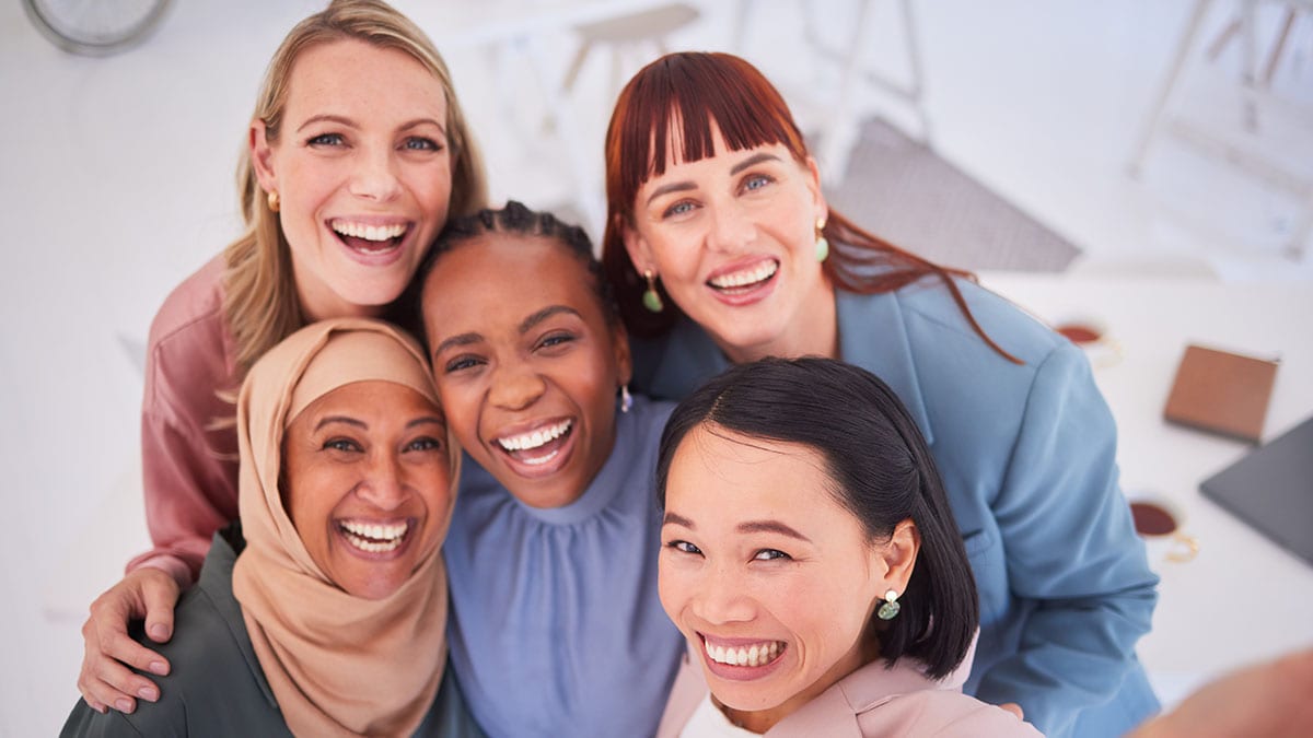 Diverse group of women posing for a picture together