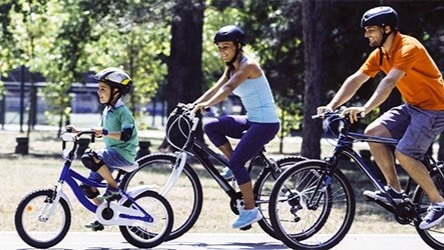 Family of 3 riding bikes