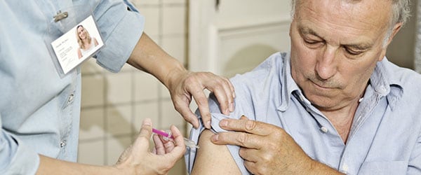 Adult male getting vaccinated with the shingles vaccine.