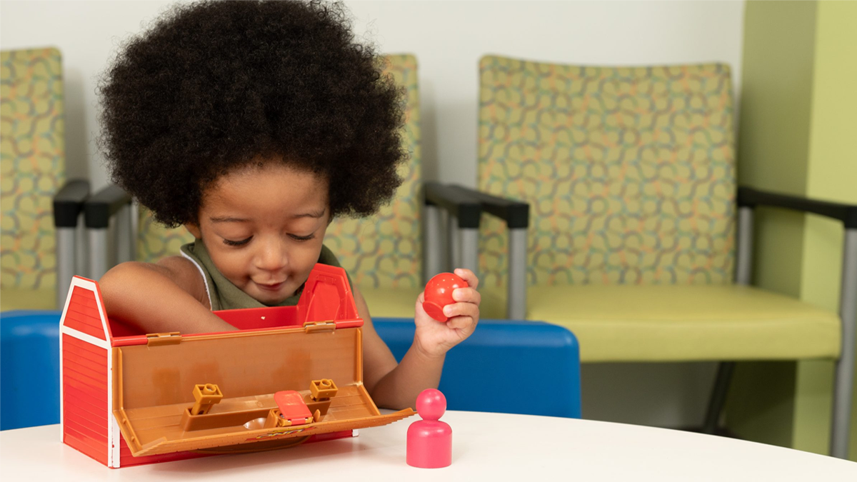 A young child engages in early intervention services