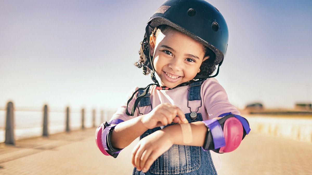Happy, smile or girl with helmet for exercise, wellness health at beach, sea or ocean