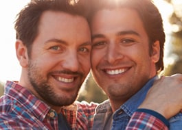 A gay couple smiling