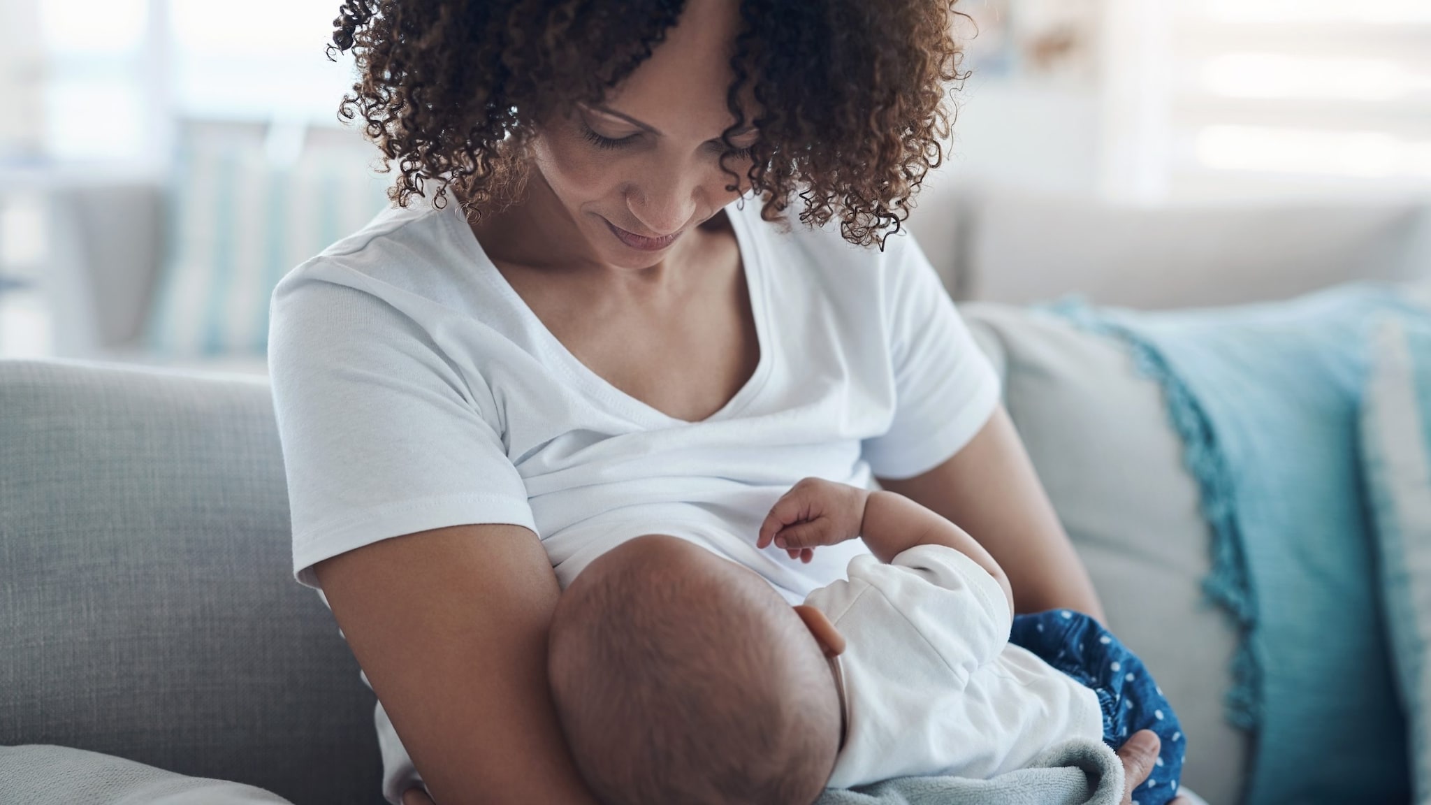 Woman breastfeeding infant.