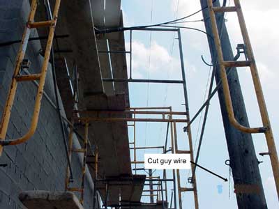 arrow pointing to cut guy wire