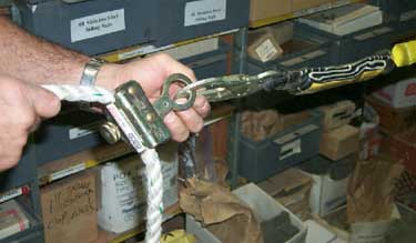 Photo D. Picture of how lanyard is assembled to a grab device that will grab the lanyard and help shorten the employees fall.