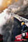 firefighter fighting fire from ladder