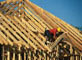 construction worker on roof trusses