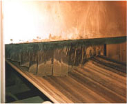 Second conveyor belt exiting chute below hopper.