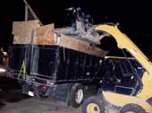 Trash truck and skid-steer loader.