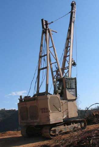 View of a yarder in transit to a new location at a logging site.