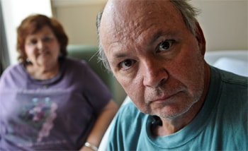 Dan Anders had a close-call with inhalation anthrax. His wife, Anne (in the background) calls him “Miracle Man.” Photo courtesy of the Star Tribune/Minneapolis-St. Paul, 2013.