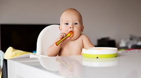 Infant eating with a spoon
