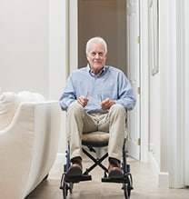 Senior man at home in a wheelchair