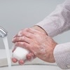 Photo of a man washing his hands