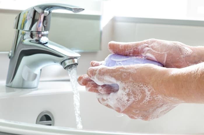 Photo of a person washing hands.