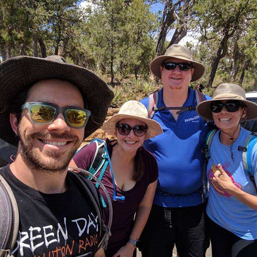 Friends staying sun-safe on their hike.