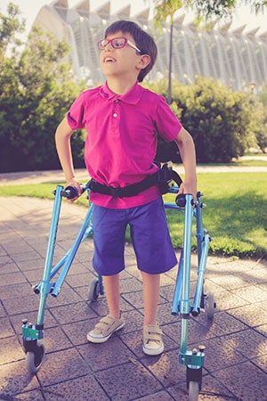 A boy using a walker