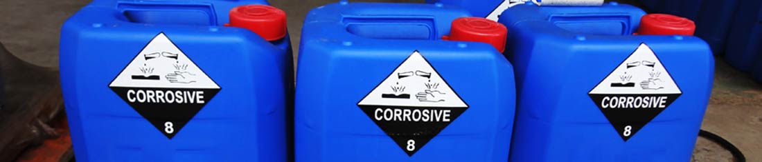Three bright blue chemical containers for corrosive liquids with warning labels