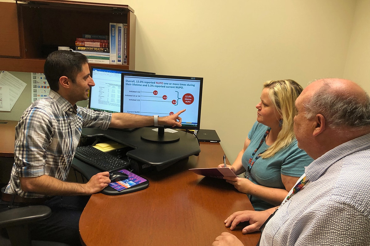 EIS Officer explains study results to CDC colleagues in an office setting.