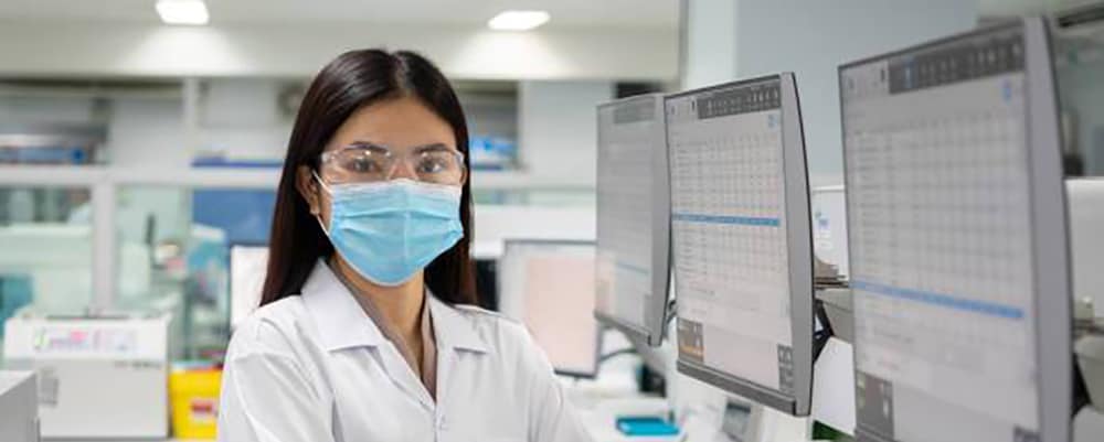 Scientist in lab wearing a mask