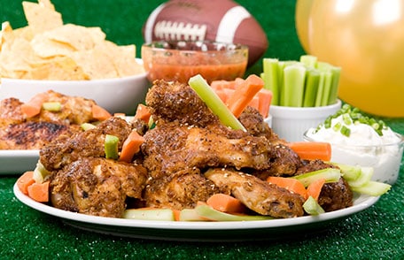 plate of wings celery and carrots for super bowl party