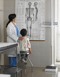 Doctor showing young patient chart of anatomy