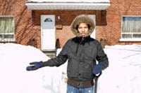 Photo: A person standingby a snow bank.