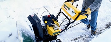Photo: A person using a snow thrower.