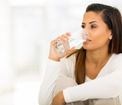 woman drinking fluoridated water