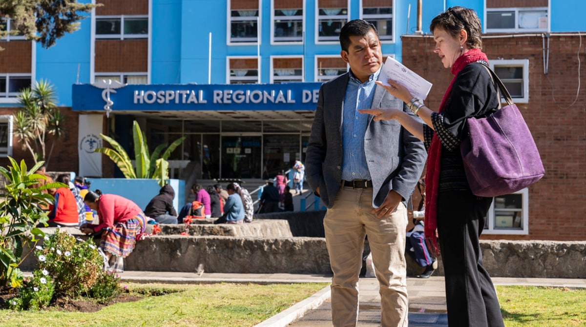Two people standing in front of hospital in Guatemala.