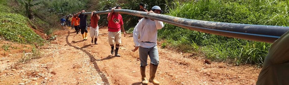 A team of public health officers, public health engineers, and villagers carry pipes to reinstall a water piping system after a massive flood in Kuala Krai District in Kelantan, Malaysia. The flood, which happened on December 24, 2014, destroyed most of the city's water supply system. Clean water was one of main concerns during and after the flood. Submitted by Rosemawati Ariffin â€“ Malaysia.