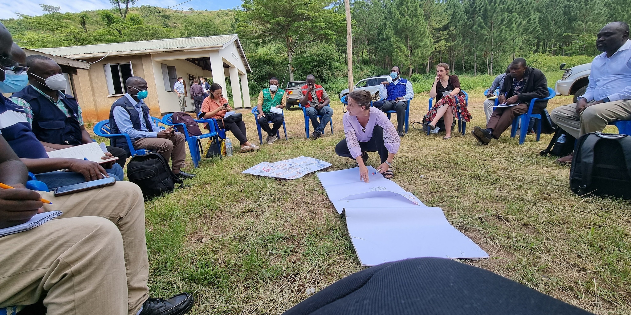 CDC Director and participants outside in Uganda organizing surveillance activities during the Ebola response.