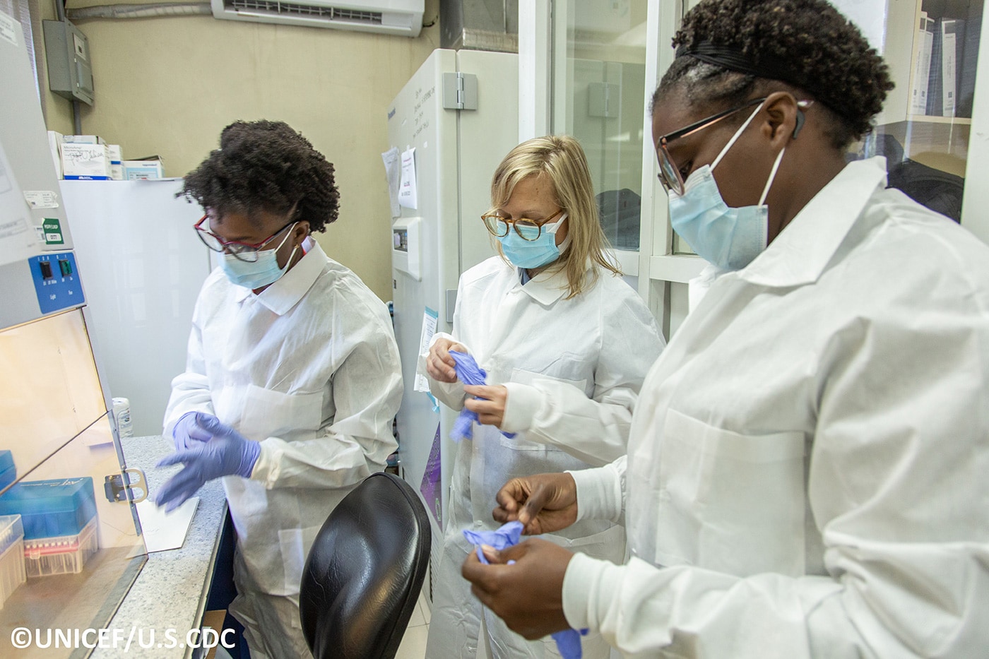 CDC microbiologist works  with staff at the molecular biology department of the National Public Health Laboratory of Haiti.
