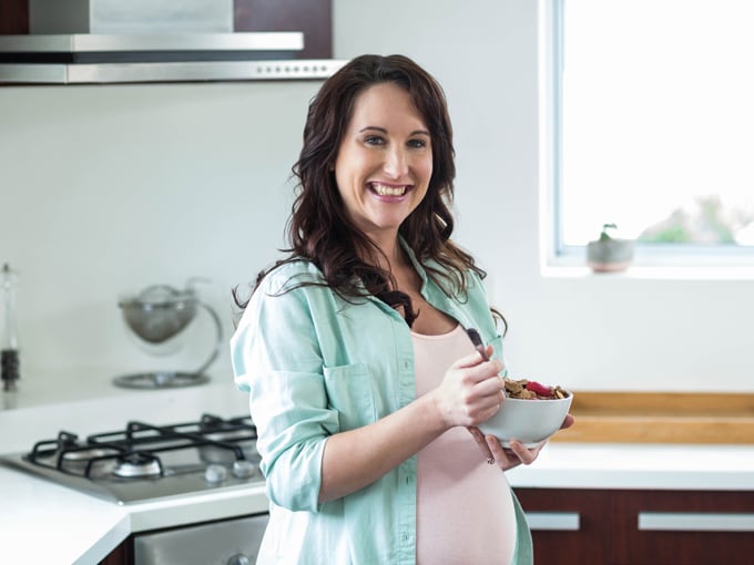 Pregnant women eating cereal