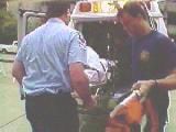 Paramedics loading a patient into an ambulance