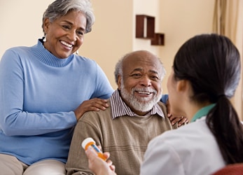 Older adults being counseled by a health professional.
