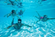 Family swimming under water.