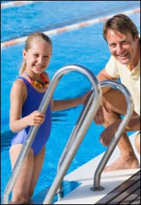 Father and duaghter at a pool.