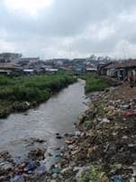 A stream contaminated with sewage and garbage in Kenya.