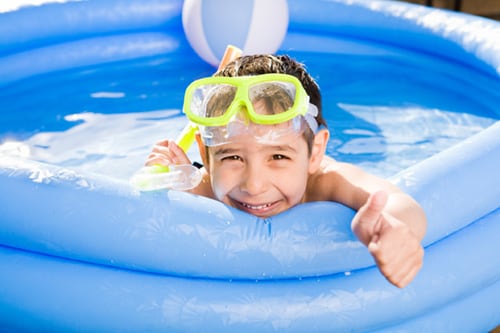 Smiling boy swimming outdoor