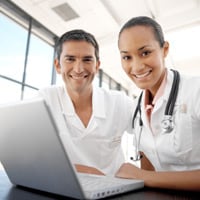 photograph of two doctors at a computer