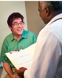 Young Asian man in consulataion with doctor