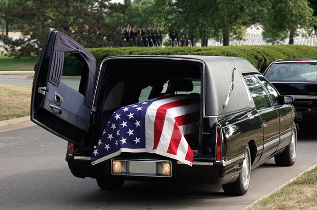 coffin loaded into a hearse