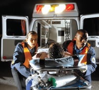 Emergency medical technicians attending to an injured person.