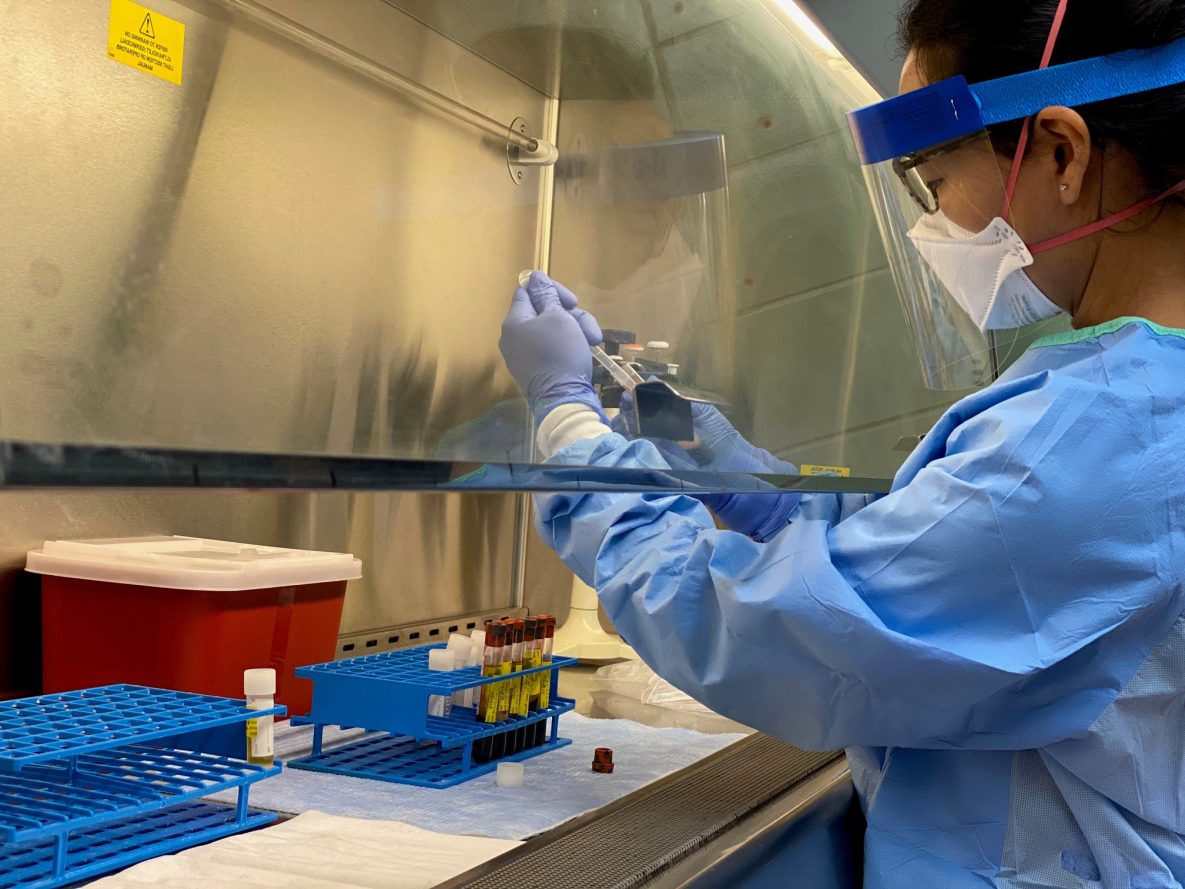 Class of 2020 LLS fellow Christine Lee processes samples during a deployment for a University of Wisconsin COVID-19 antigen study.
